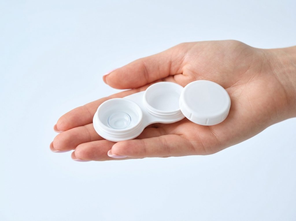 Contact lens case held in hand
